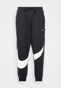 Pantalones de chándal negros con un diseño curvado en blanco, cinturilla elástica con cordón y puños elásticos. Incluye detalle de bolsillo lateral.