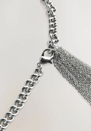Silver metal chain necklace featuring large links, a lobster clasp, and strands of fine chain cascading from one side.