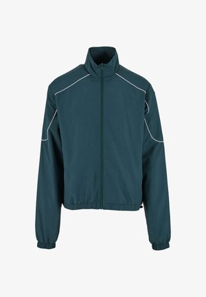 Dark teal jacket with a high collar, front zipper, elastic cuffs, and light-colored piping along shoulders and seams. Smooth fabric texture.