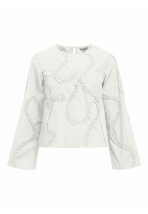 Blusa bianca in cotone con maniche lunghe, caratterizzata da dettagli a volant strutturati in un motivo astratto e fluente. Chiusura con zip sul retro.