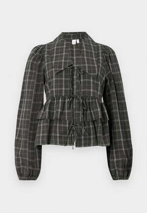 Blouse à carreaux verts avec un ourlet en peplum, détails à nouer, manches longues bouffantes et col, fabriquée en tissu léger.