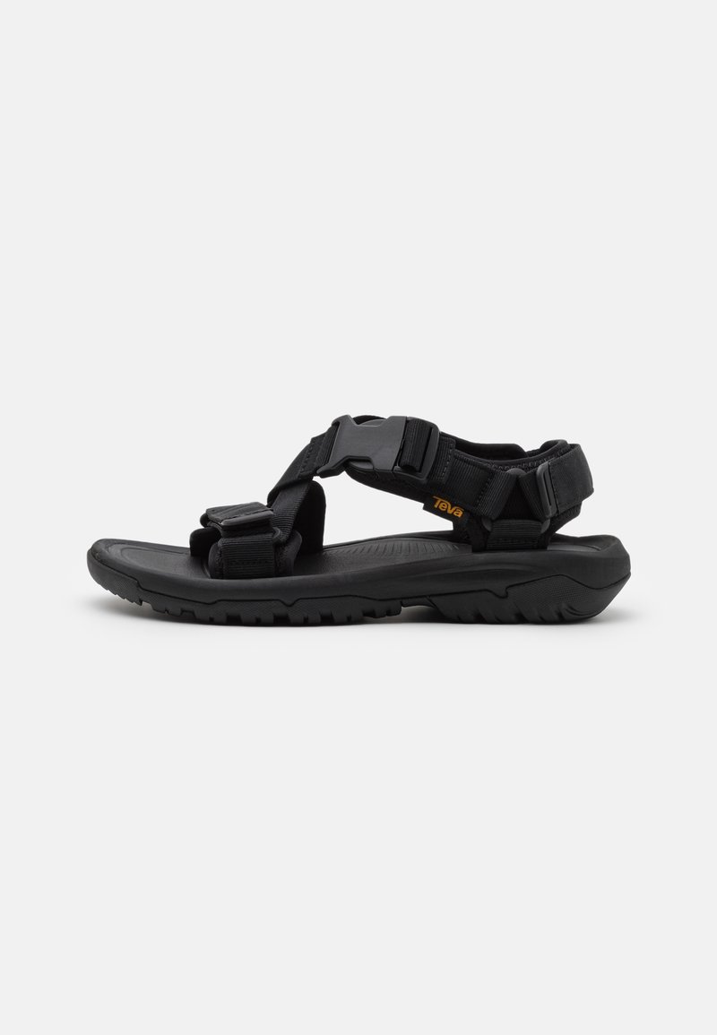 Black outdoor sandal with adjustable nylon straps, a contoured sole, and textured footbed. Features a durable rubber outsole for traction.