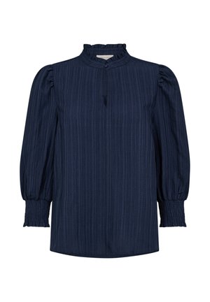 Marineblauwe blouse met lange mouwen, voorzien van een textuur, geribbelde ontwerp, hoge kraag en geplooide pofmouwen. Voorzien van knopen aan de voorkant en een split.