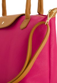 Bright pink bag with a textured surface, complemented by tan leather handles and trim. Features a flap closure and detachable strap.
