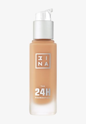 Pump foundation in a clear glass bottle with a silver cap, labeled "THE 24H FOUNDATION," and a soft tan liquid, smooth texture.