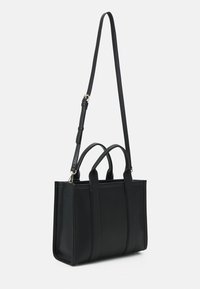 Black faux leather tote bag with dual top handles and a detachable shoulder strap. Features vertical stitching and a structured shape.