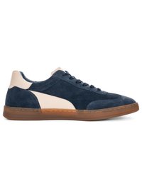 Low-top navy suede sneaker with white leather accent on side and heel, brown rubber sole, and lace-up closure.
