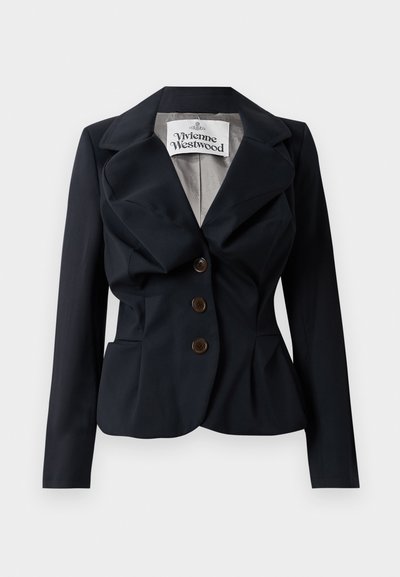 Jūrinis švarkas, pagamintas iš lygaus audinio, su peplum juosmeniu, dideliais atlapais ir trimis rudais mygtukais priekyje. Matoma Vivienne Westwood etiketė.