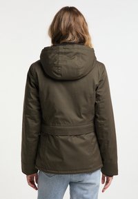 Olivgrön huva jacka med insvängd midja, slät textil och minimala sömmar. Har en stor, mjuk huva för extra skydd.