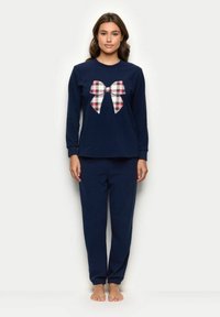 Mørkeblå pyjamas sæt med en langærmet top med et stort plaidet bue-grafik og matchende bukser med en afslappet pasform og samlede manchetter.