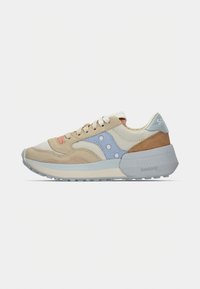 Beige suede sneaker with pastel accents in blue and orange, featuring a textured outsole and layered design elements. Logo on heel.