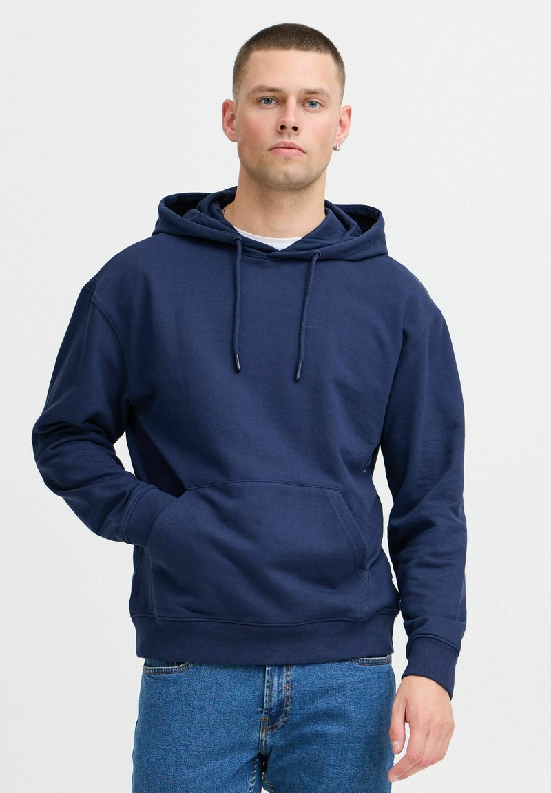 Navy blue pullover hoodie made of soft fabric, featuring a kangaroo pocket, drawstring hood, and ribbed cuffs and hem.