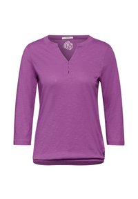 Violette Bluse mit langen Ärmeln und einem leicht V-förmigen Ausschnitt, ausgestattet mit einer kurzen Knopfleiste und einem weichen, strukturierten Stoff. Abgerundeter Saum.