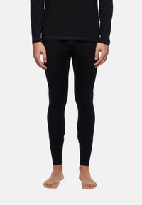 Black thermal base layer leggings made from a smooth, stretchy fabric. Features a close-fitting design and flat seams for comfort.