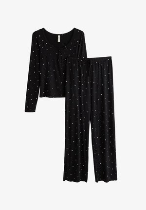 Sorte pyjamasæt med en langærmet top og matchende bukser. Begge dele har et stjernemønster i hvid, lavet af blødt stof.