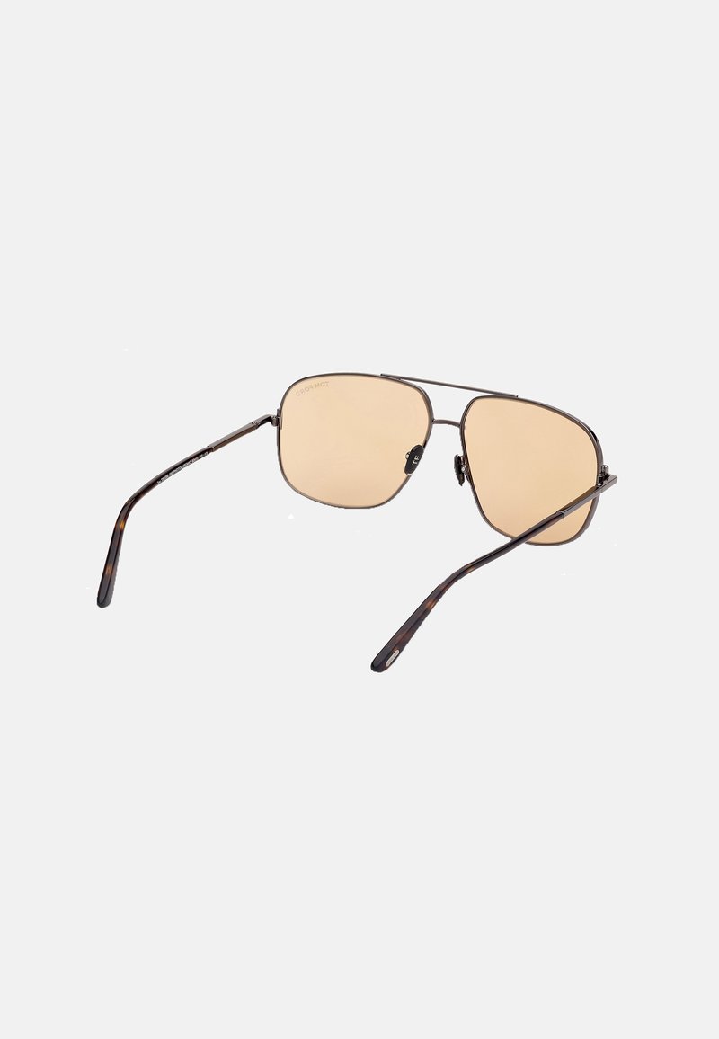 Sunglasses featuring a brown tortoiseshell frame, gold-toned accents, and light brown lenses with a geometric lens shape.