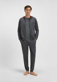 Gray zip-up hoodie with maroon accents, paired with a matching gray crew neck shirt and sweatpants. Made from soft fabric, relaxed fit.