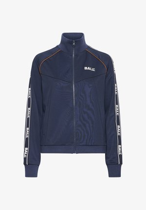 Veste zippée bleu marine avec col montant, poches latérales et passepoil marron contrastant ; présente des logos blancs "BALL" le long des manches.