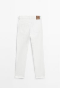 MID-RISE SLIM FIT - Jeans a zampa - white