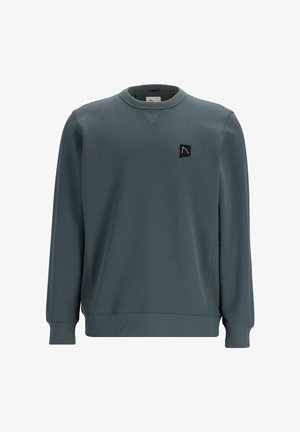 Sötét türkiz színű pulóver hosszú ujjakkal, kerek nyakkal, bordás mandzsettával és aljjal, amelyen egy kis fekete logó található a mellrészen.