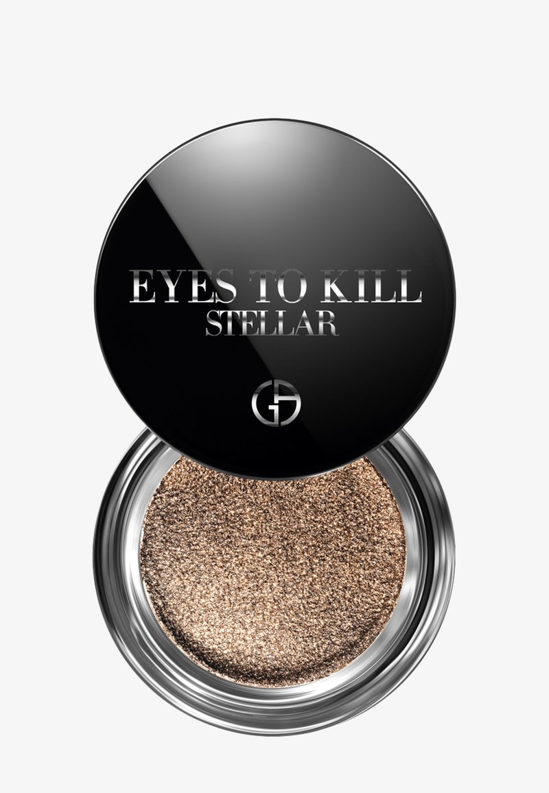 Rund kompakt med et reflekterende svart lokk merket "EYES TO KILL STELLAR." Inneholder bronsefarget glitrende øyenskygge i en glatt, metallisk finish.
