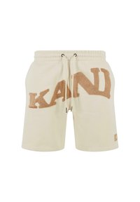 Beige shorts made of soft fabric, featuring a textured brown logo "KAND" on the front, elastic waistband, and drawstring closures.