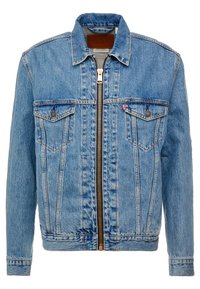 Denimjacka i ljusblått med dragkedjestängning, två bröstfickor och klassisk krage. Har detaljer med sömnad och en logotyp insidan.