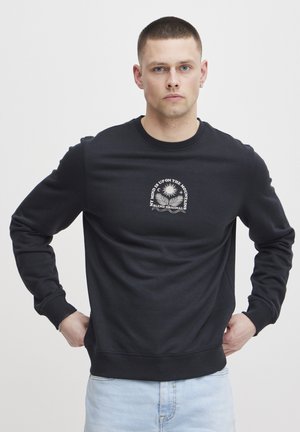 Black sweatshirt made of soft fabric, featuring a round neckline and long sleeves. Centered chest graphic with text and decorative design.