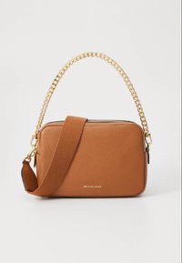 Tan leather crossbody bag featuring a textured finish, a gold chain handle, and a brown fabric strap. Includes logo detail on the front.