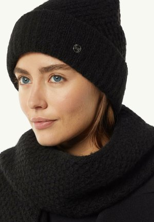 Czarna dziana czapka typu beanie z ryżowym splotem i metalowym logo, w zestawie z dopasowanym czarnym szalikiem o grubym splocie.