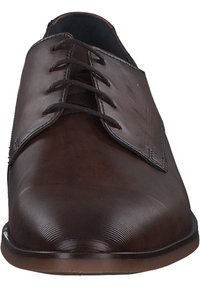 Brown leather lace-up shoes with a smooth finish and rounded toe. Features prominent stitching and six eyelets for laces.