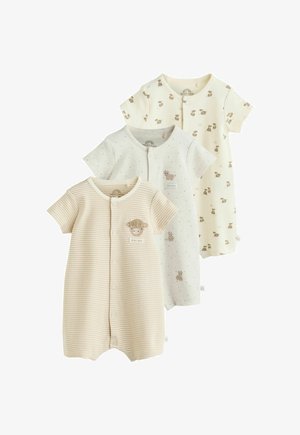 Trei salopete scurte pentru bebeluși, în bej deschis și alb, cu modele cu vaci și buline, nasturi cu capse în față și gât rotund.