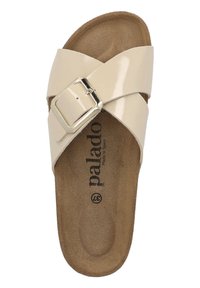 Beige, glossy cross-strap sandal with a silver buckle and a textured brown insole. Brand name "palado" printed on the footbed.