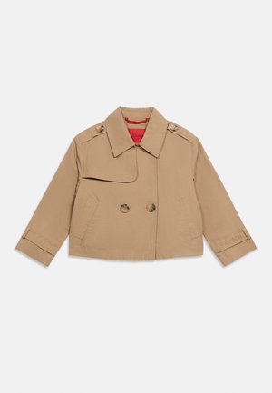 Beige cropped trench coat with double-breasted buttons, shoulder straps, two front pockets, cuff straps, and red inner lining.