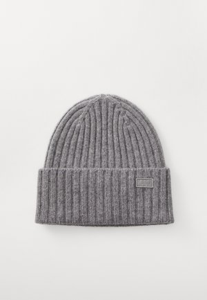 Gray ribbed knit beanie with a folded cuff and a small logo tag on the front. Soft texture, cylindrical shape, minimalistic design.