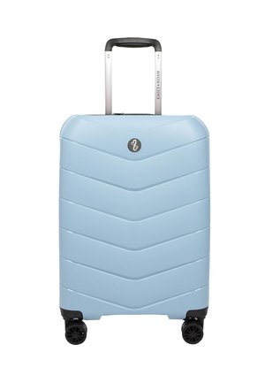Hard-shell suitcase in light blue with a chevron pattern, extendable silver handle, and four black wheels for mobility.