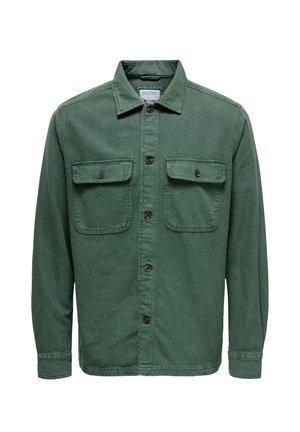 Green cotton shirt jacket with a collar, two chest pockets, buttoned front, and long sleeves. Features black buttons and a textured finish.