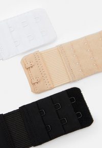 Three fabric bra extenders: white, nude, and black, each with hooks and loops for attachment. Smooth texture and adjustable design.