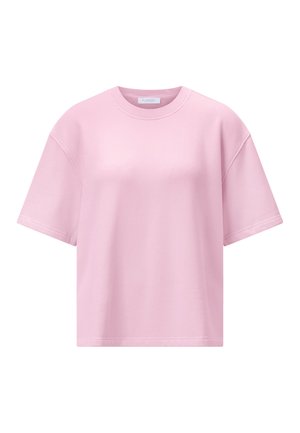 Hellrosa oversized T-Shirt mit kurzen Ärmeln, rundem Ausschnitt und sichtbaren Nahtdetails an Schultern und Ärmeln.