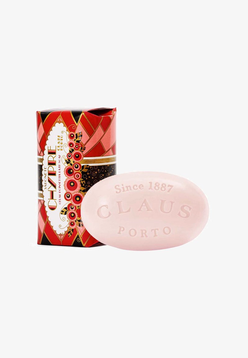 Rose-colored oval soap labeled "Claus Porto" with a decorative, red and black patterned box featuring floral accents and golden bands.