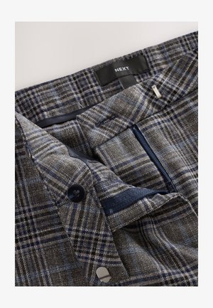 Bukser lavet af gråt hundetandsmønsterstof med blå og sorte tern. Har lynlåslomme, knaplukning og vævet label.