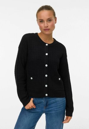 Black knitted cardigan with long sleeves, textured fabric, featuring a round neckline, front pockets, and large white buttons.