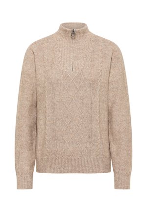 Beige gebreide trui met hoge kraag en halve rits. Bevat textuurpatronen van diamant en kabels. Geribbelde manchetten en zoom.