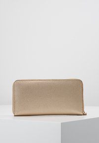 Gold, textured leather wallet with a rectangular shape, a smooth zipper closure, and no visible logos or embellishments.