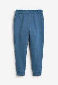 Blauwe sweatpants van zachte stof met een elastische tailleband. Heeft taps toelopende benen en ribbels bij de enkels.