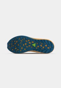 Semelle de chaussure avec une accroche bleue et orange présentant des motifs de bande de roulement triangulaires et irréguliers, et un petit logo triangulaire vert près du centre.