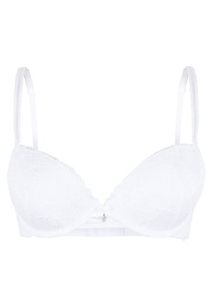Reggiseno bianco in pizzo con coppe sagomate, spalline regolabili e un fiocco decorativo al centro. Il motivo floreale testurizzato arricchisce il design.