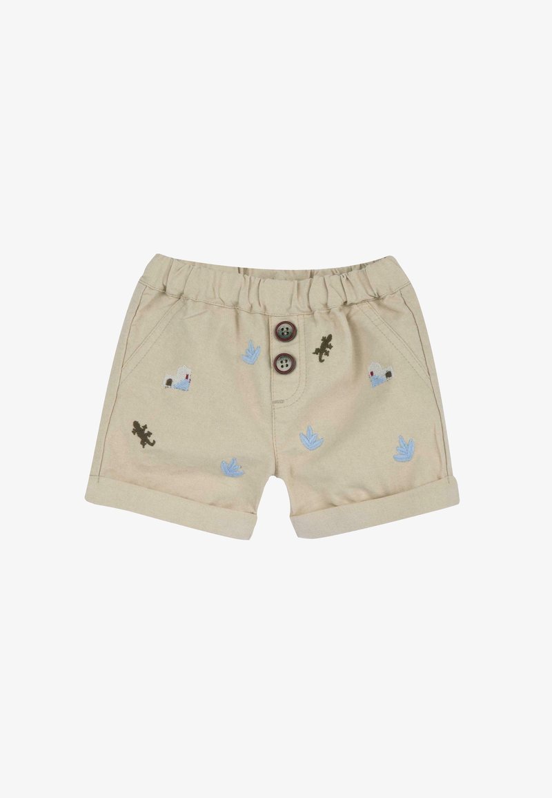 Shorts beiges avec une taille élastique, deux boutons marron et des détails brodés représentant des plantes et des lézards en bleu et vert.