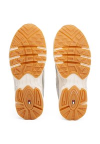 Lightweight athletic shoes featuring a textured, orange rubber sole with a prominent grip pattern and white midsole accents.