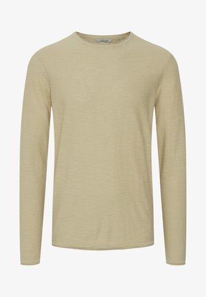 Langermet skjorte i lys beige, rund hals, myk tekstur, avslappet passform, med subtile sømdetaljer og uten synlige mønstre.